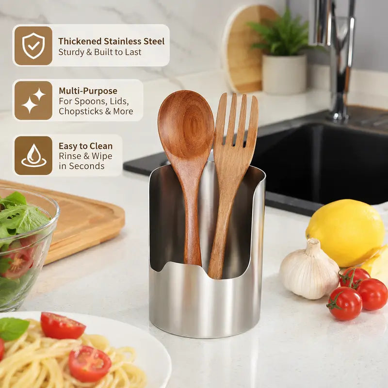 Brushed stainless steel utensil organizer beside sink and fresh kitchen ingredients